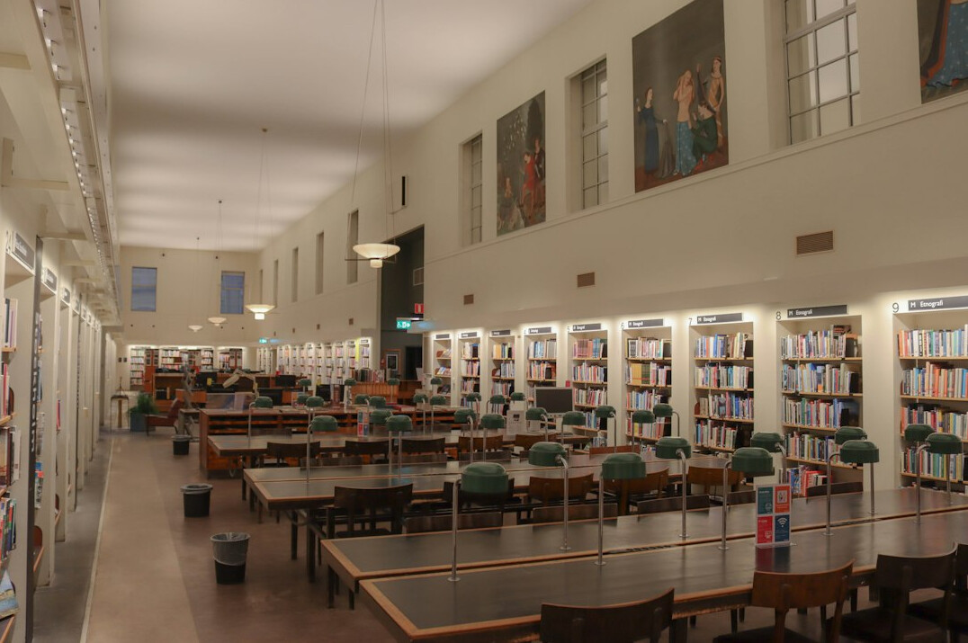 Quiet historic library reading room with tall bookshelves